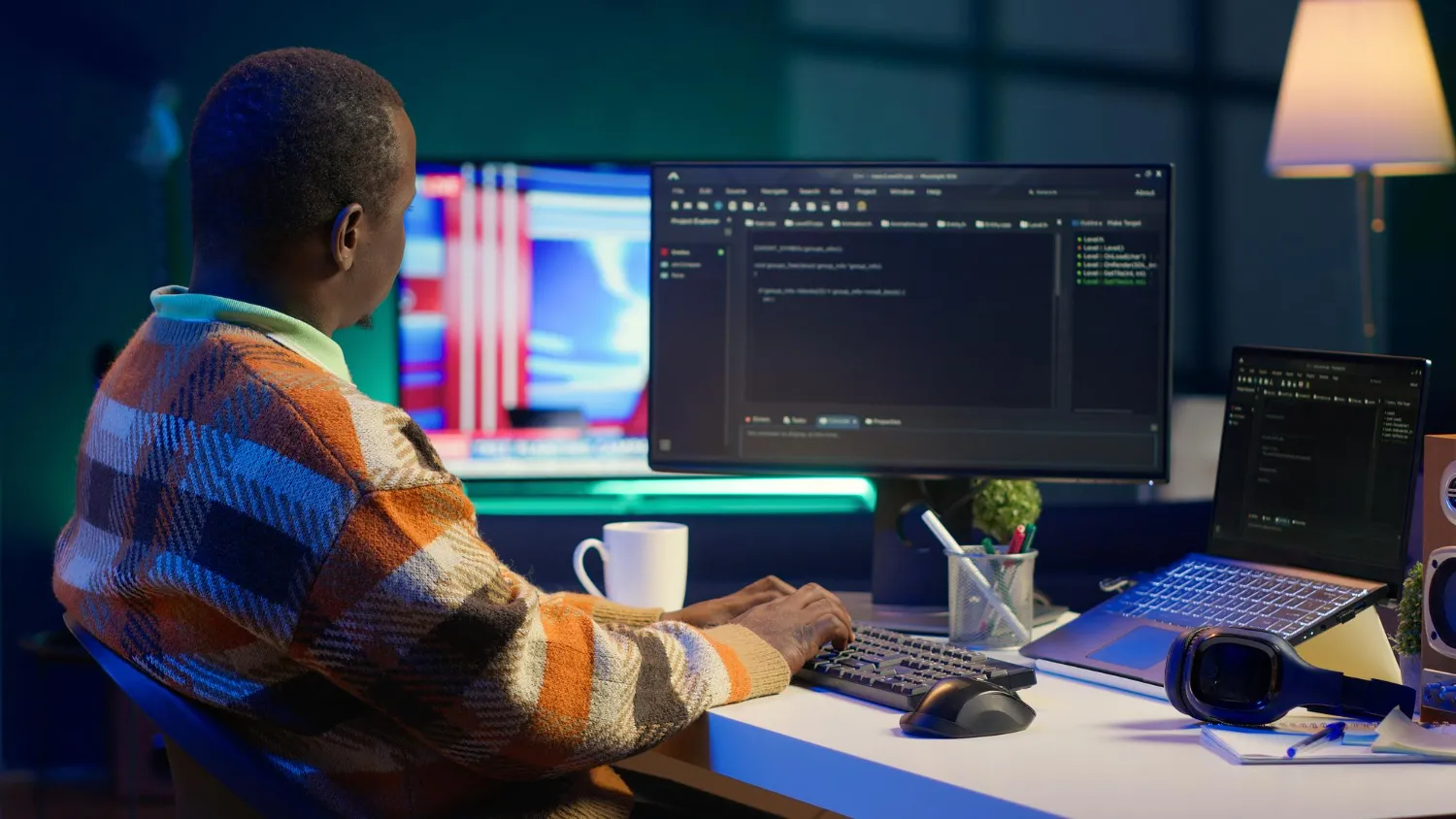 developer working on laptop at desk professional setup